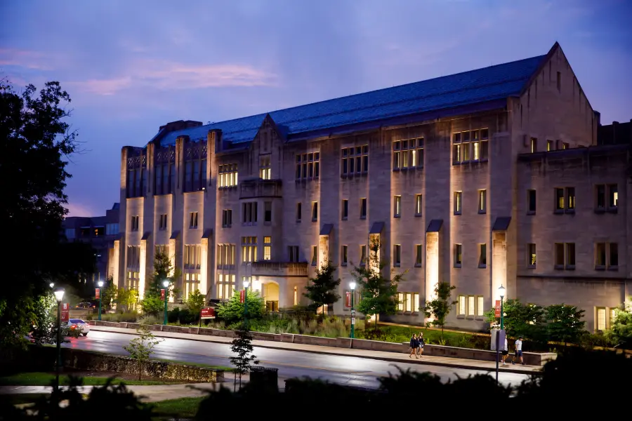 A building is pictured at twilight with up-lights illuminating the side of the building.