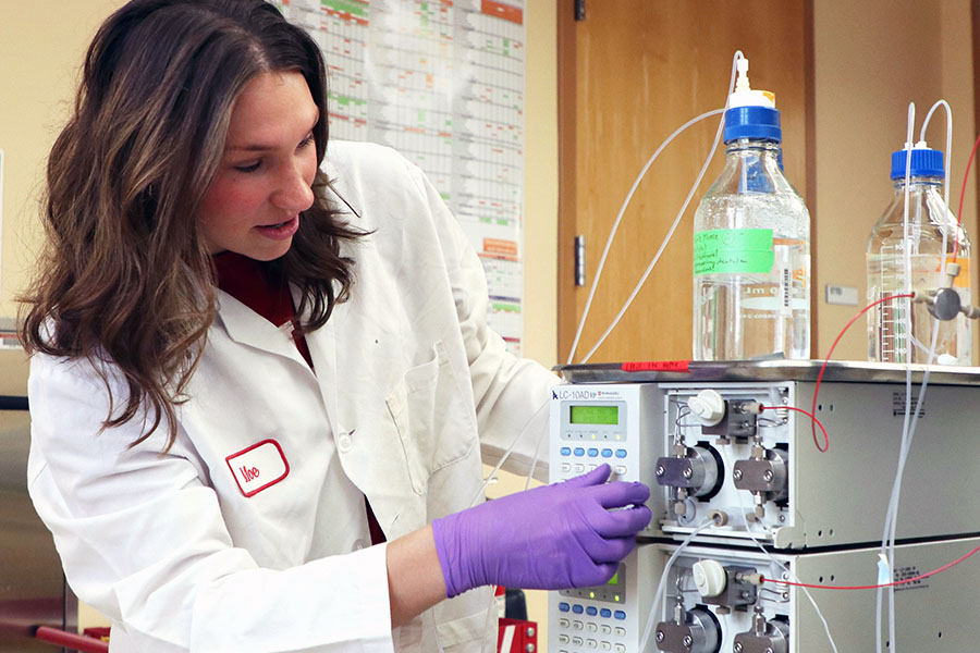 An IU researcher adjusts a machine in the lab.