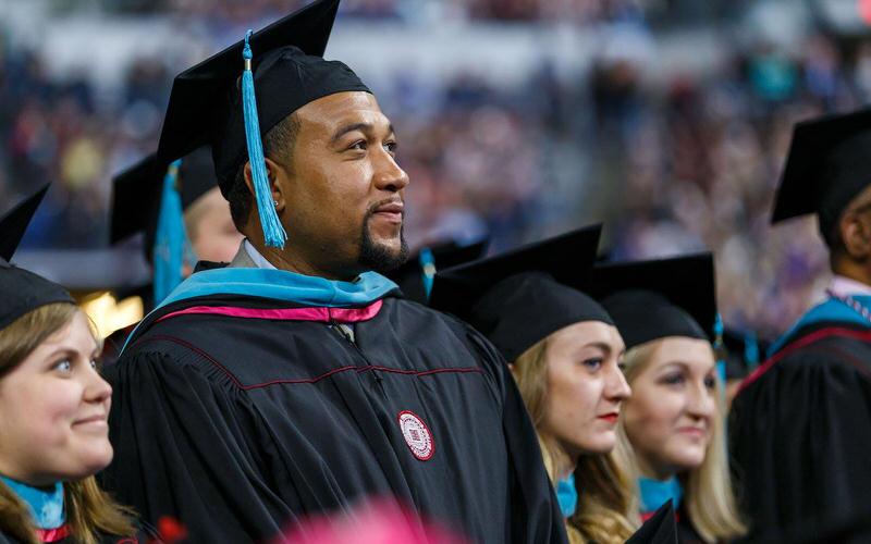 IU graduate at graduation ceremony.