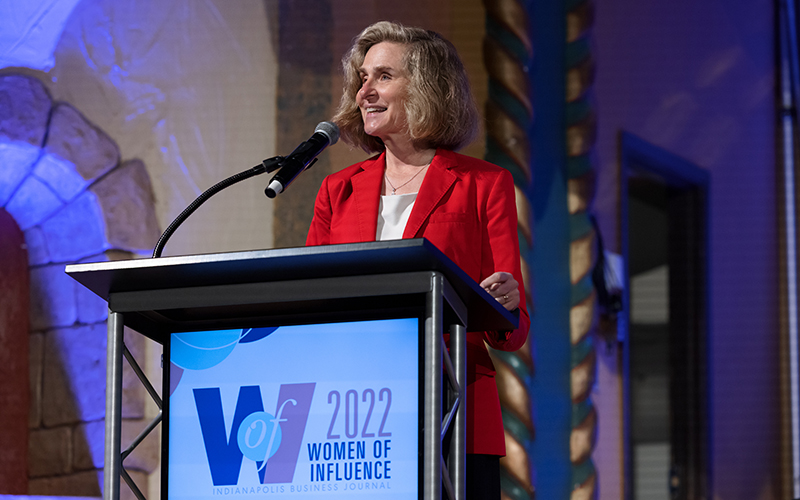 IU President Whitten speaks at a podium that says, "2022 Women of Influence"
