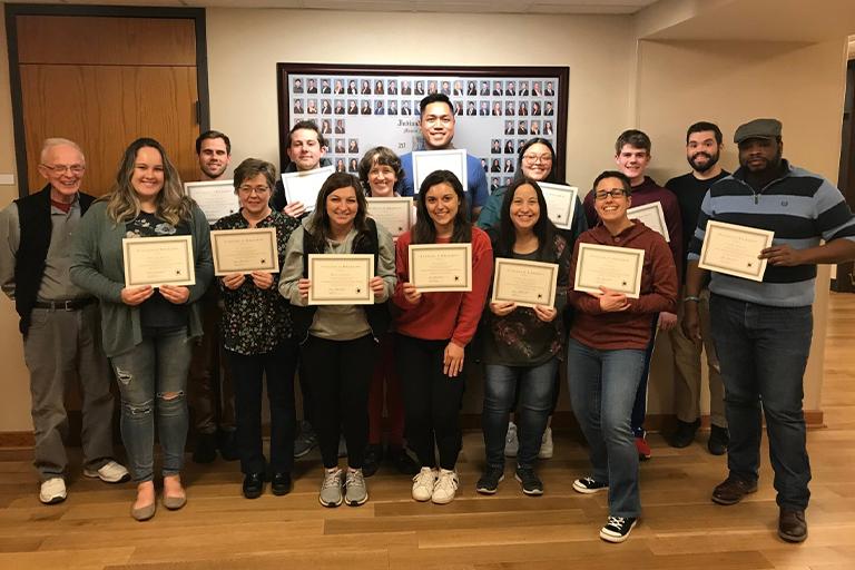 Students showing their certificates for completing the Access to Justice Program at the Maurer School of Law.