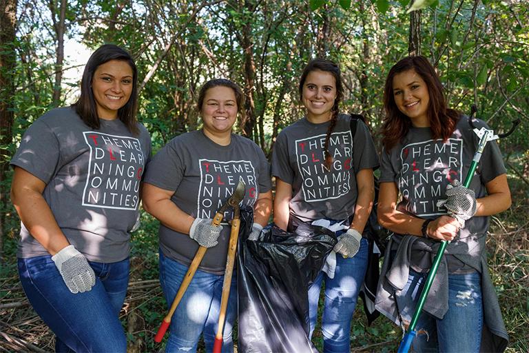 Four IUPUI students participating in a service learning activity.