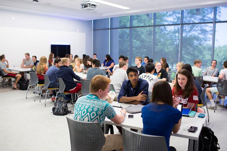 Students in classroom having group discussions.