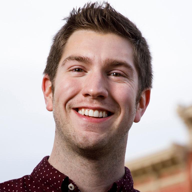 Man standing outside smiling.