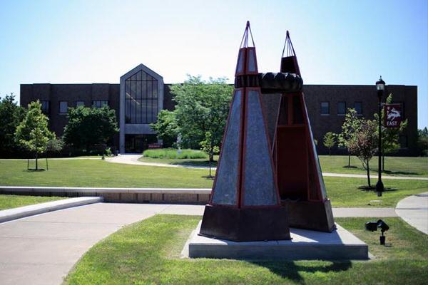 Triangular sculpture in front of large building on IU East campus.