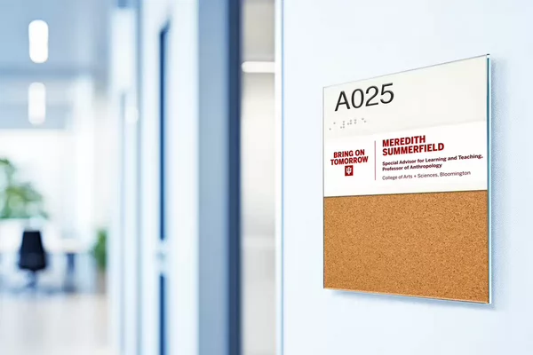 A bright office space with a Type E sign outside an office door