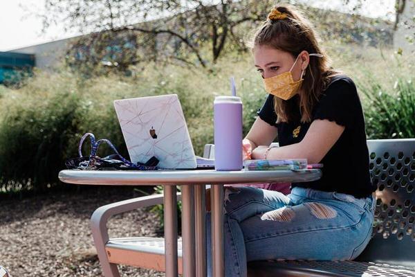 IUPUI student working on computer on campus.