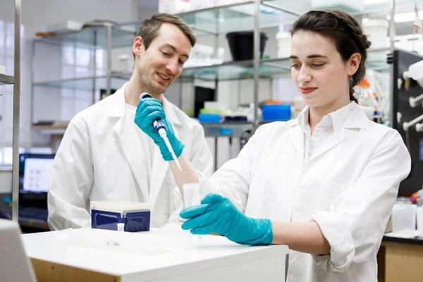 IU undergraduate student learning how to do research in a lab.