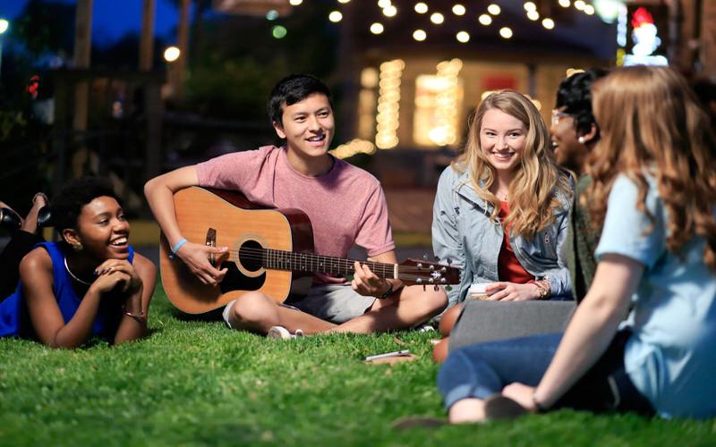 Students enjoying time outside with music.