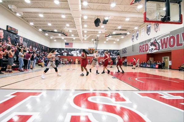 Women playing basketball at IU East arena.