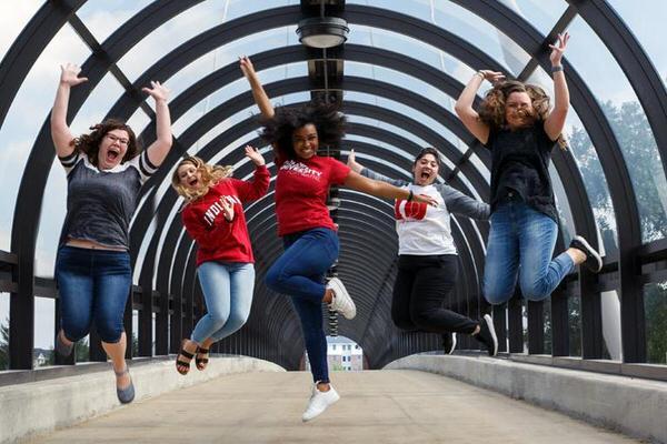 Group of undergraduate students jumping.