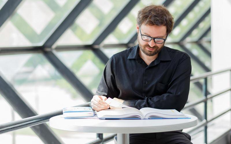 Man sitting at a table studying.