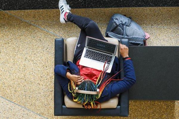 Person with a computer on their lap.