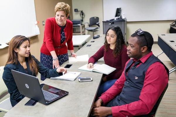 Group of students meeting with faculty.