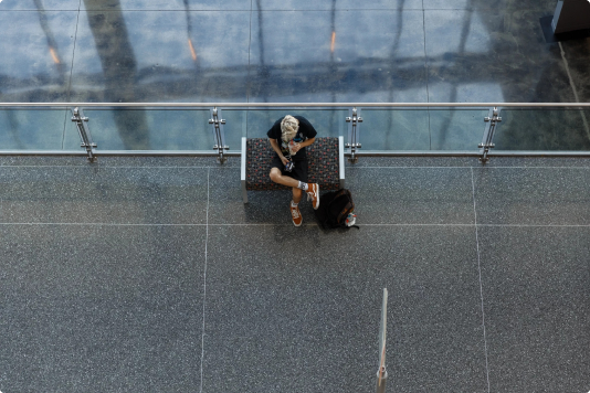 Overhead view of a student sitting and looking at their phone.