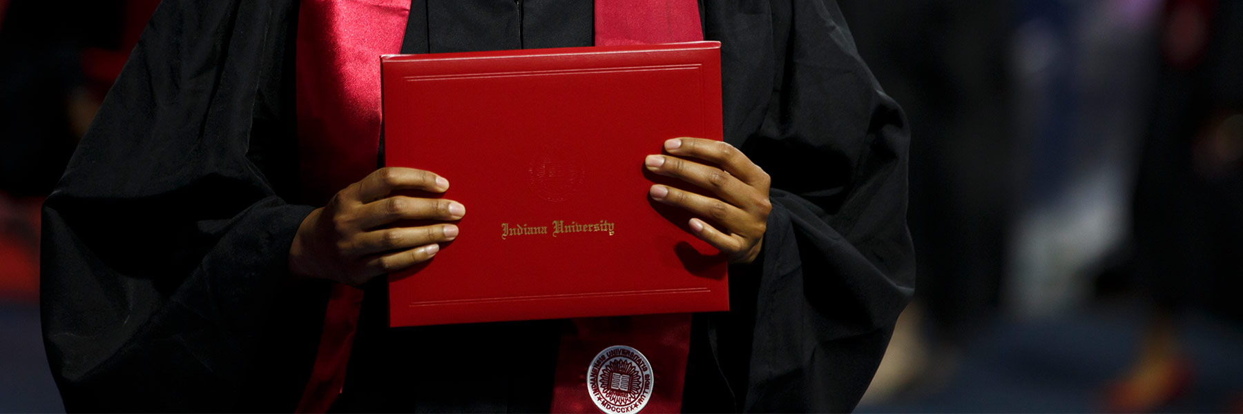 Hands holding a diploma cover